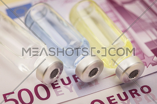 Several vials of medicine on a ticket of 500 euros, concept of copayment pharmaceutical