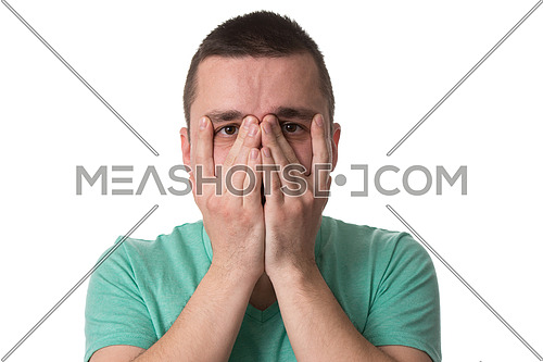 Portrait Of Young Stressed Caucasian Man Covers His Face With Hands Isolated On White Background