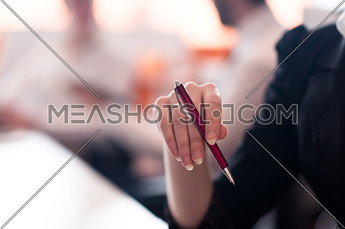 close-up of woman hands holding pen on business meeting