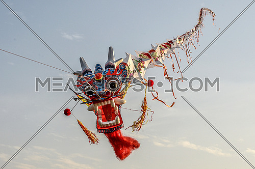 dragon shaped kite flying in the sky