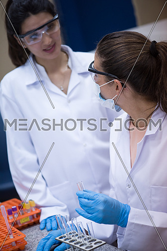 Young middle eastern woman enjoys working in a large modern laboratories