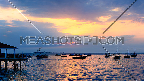 Typical boats docked in the port of  Stone Town ,Zanzibar, Tanzania republic, at sunset.