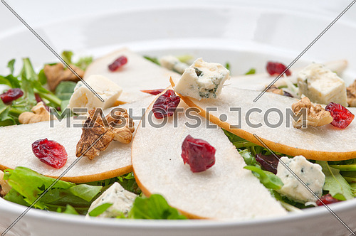 Fresh pears arugula gorgonzola cheese salad with cranberry and walnuts