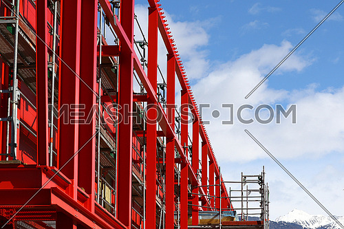 New steel beam construction being built against blue skies and white clouds