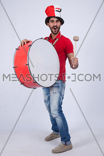 A young man holding big drums cheering on a white background