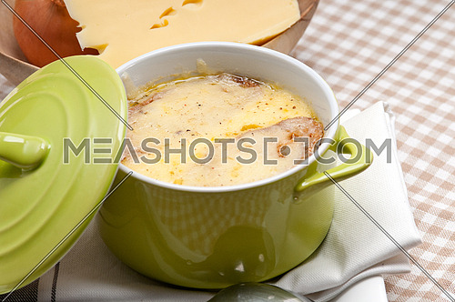 oinion soup on clay pot with melted cheese and bread on top