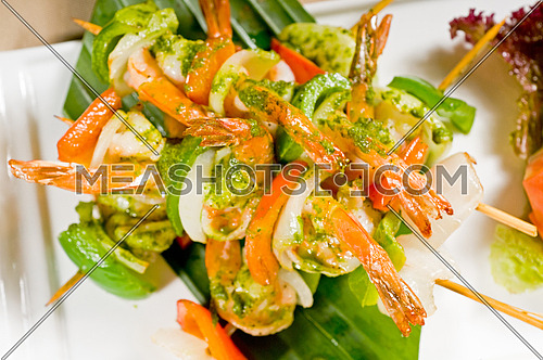 fresh and colorfull grilled shrimps and vegetables skewers on a palm leaf ,thai style