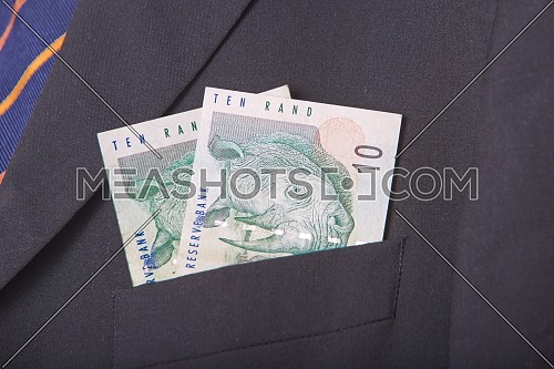 South African Rands in the pocket of a suit