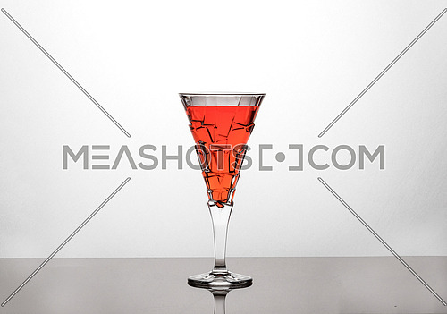 Unique glassware contains red liquid
