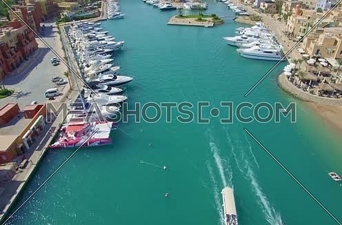 Drone shot flying above Al Gouna Marina with moving boats at Day 