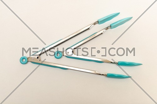 2 sizes of silicone tongs , in baby blue color. top view