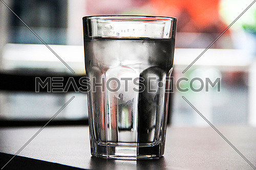 A cold glass of water in a dramatic lighting