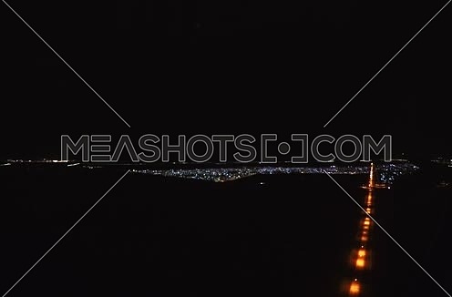 from inisde shot form plane window while flying at Night