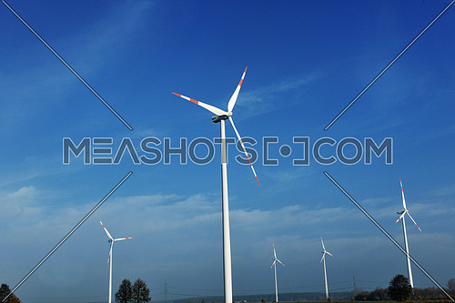 wind turbine  generating eco friendly renewable  electricity energy on blue sky