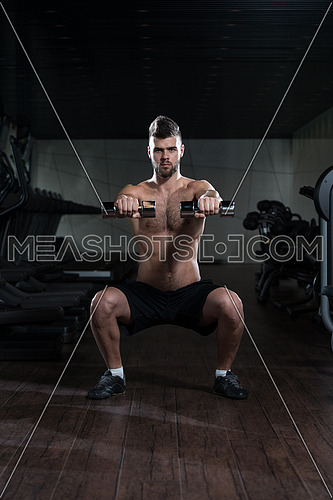 Young Man Performing Dumbbell Squats - One Of The Best Bodybuilding Exercise For Legs