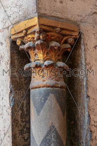 Golden capital of a small decorative pillar (column) with engraved floral inscriptions at the ancient public mosque of Sultan Hassan, Old Cairo, Egypt