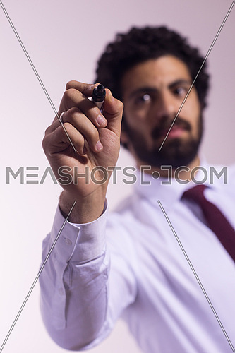 middle eastern business man writing with  marker on virtual screen
isolated on white