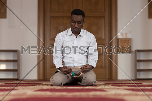 Black African Muslim Man Is Praying In The Mosque