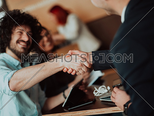 Business people or lawyers shaking hands finishing up meetings or negotiations in sunny offices. Business handshake and partnership