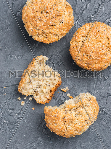 Muffins with chia seeds. Homemade muffin on black concrete textured background. Top view or flat lay