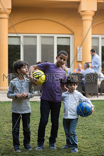 portrait of middle eastern boys with a ball sunny summer day in the yard