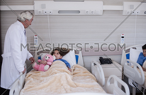 arabian mischievous and beauty kid get treatment by mature doctor in modern hospital