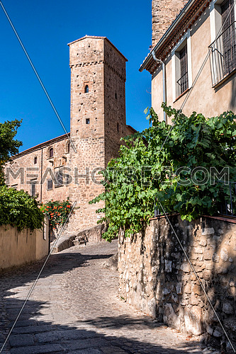 Trujillo, Spain - July 14, 2018: Torre de los enamorados, next to Romanesque tower of the Church of Santiago and that of the strong house of Luis Chaves, "the old". Trujillo, Caceres Province, Spain
