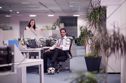 relaxed young couple at office finishing their job