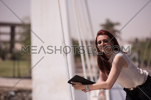 middle eastern business woman with tablet computer in office district