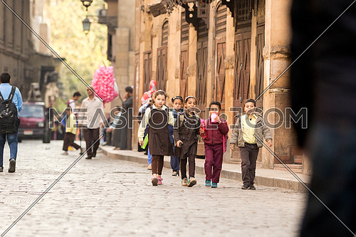Young Girls walking to school early morning in El-Moez Street