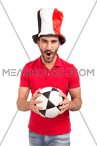 A young man encourages the Egyptian football team wearing a hat with the flag of Egypt