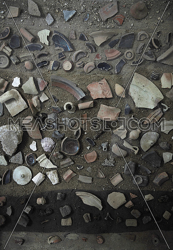 broken pottery pieces on the ground