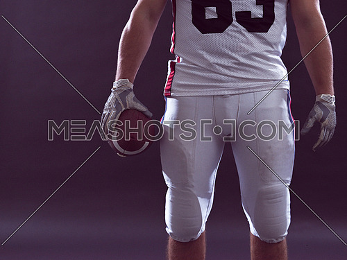 Closeup Portrait of a strong muscular American Football Player isolated on gray