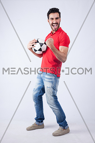 A young man wearing red t-shit and holding a football on a white background