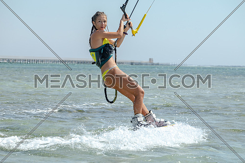 Female Kite Surfer while surfing in Red Sea at day.