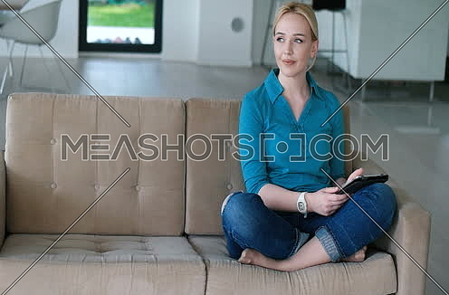 blonde using tablet in modern villa