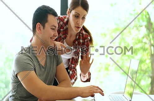 Couple shoping online and having fun with credit card