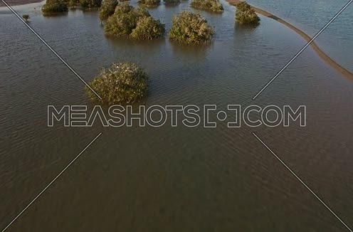 Drone shot flying above lagoon at Sunset