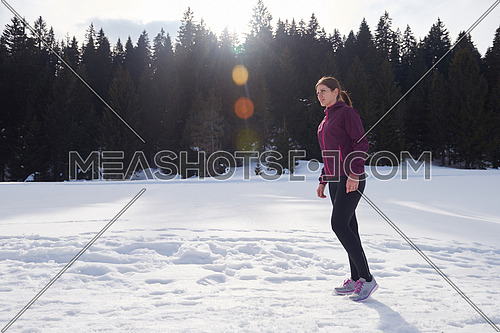 yougn woman jogging outdoor on snow in forest, healthy winter lifestyle and recreation