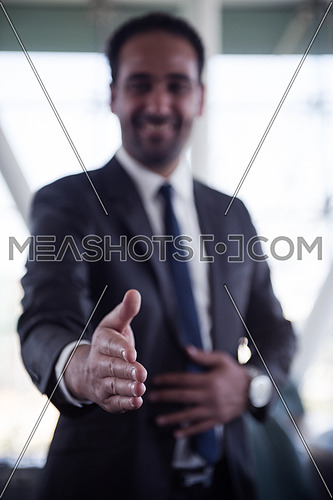 young middle eastern business man giving handshake
