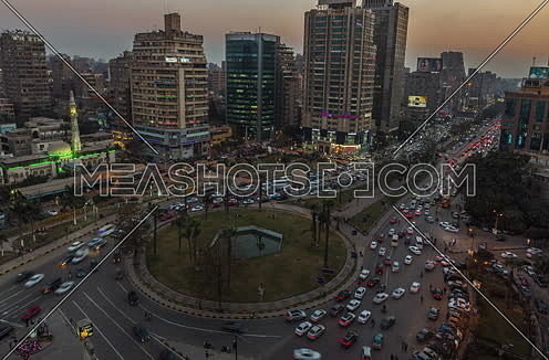 fixed shot for traffic in Moustafa Mahmoud Square at Cairo from Day to Night