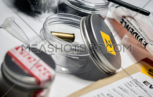 Evidence of crime scene, bullet cap in laboratory scientist, conceptual image, horizontal composition