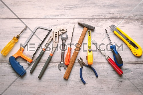 Screwdriver,hammer,tape measure and other tool for construction tools on gray wooden background with copy space,industry engineer tool concept.still-life.