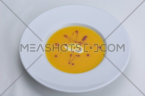 vegetable cream soup closeup isolated on white background