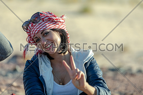 Close up for female tourist wearing bedouin traditions headscarf at Ain hodouda in Sinai at day