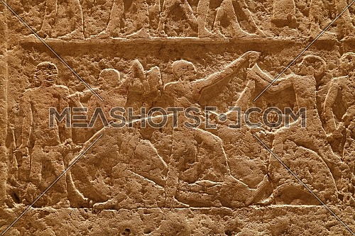 Close up background of antique stone wall with carved ancient Egyptian bas relief, front view