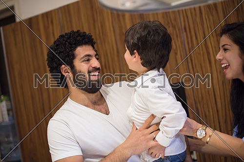 young middle east father and mother with children spend cheerful time in the kitchen