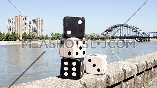 Dices Resting On The Wall With River And Cityscape in Background