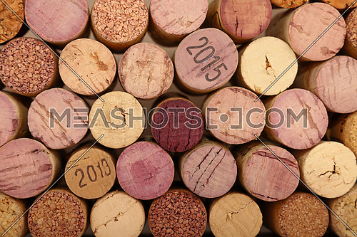Close up background pattern of many assorted stacked used red wine corks