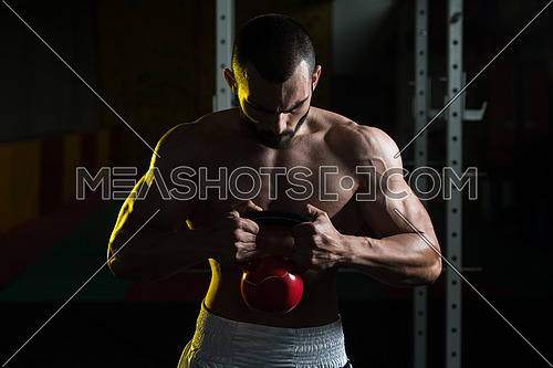 Young Man Working With Kettle Bell In Gym